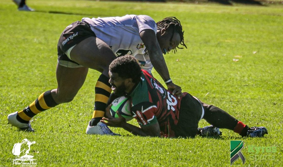 Kenya Simbas Jone Kubu brought down by a Zimbabwean Opponent. Photo Courtesy/ Kyros Sports
